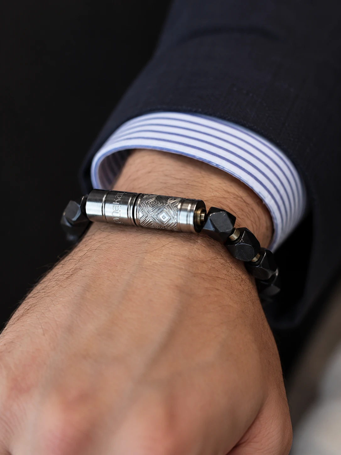 O-Punch Silver Edition worn on the wrist — Araratian obsidian cigar tool bracelet with integrated punch cutter, nubber and cleaner by Vanakat