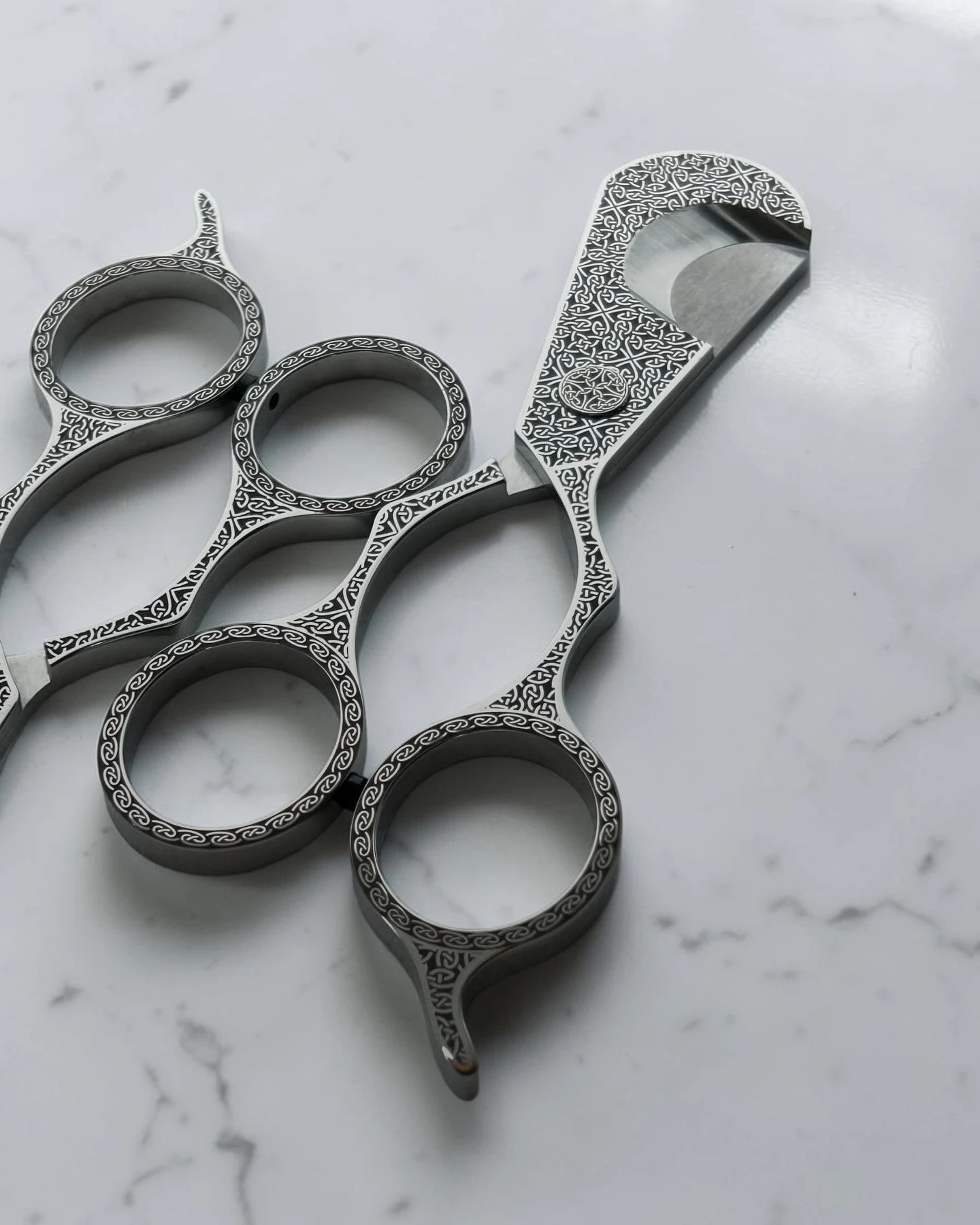 Celtic Knot cigar scissors beside a cigar – laser-engraved Japanese scissors in context