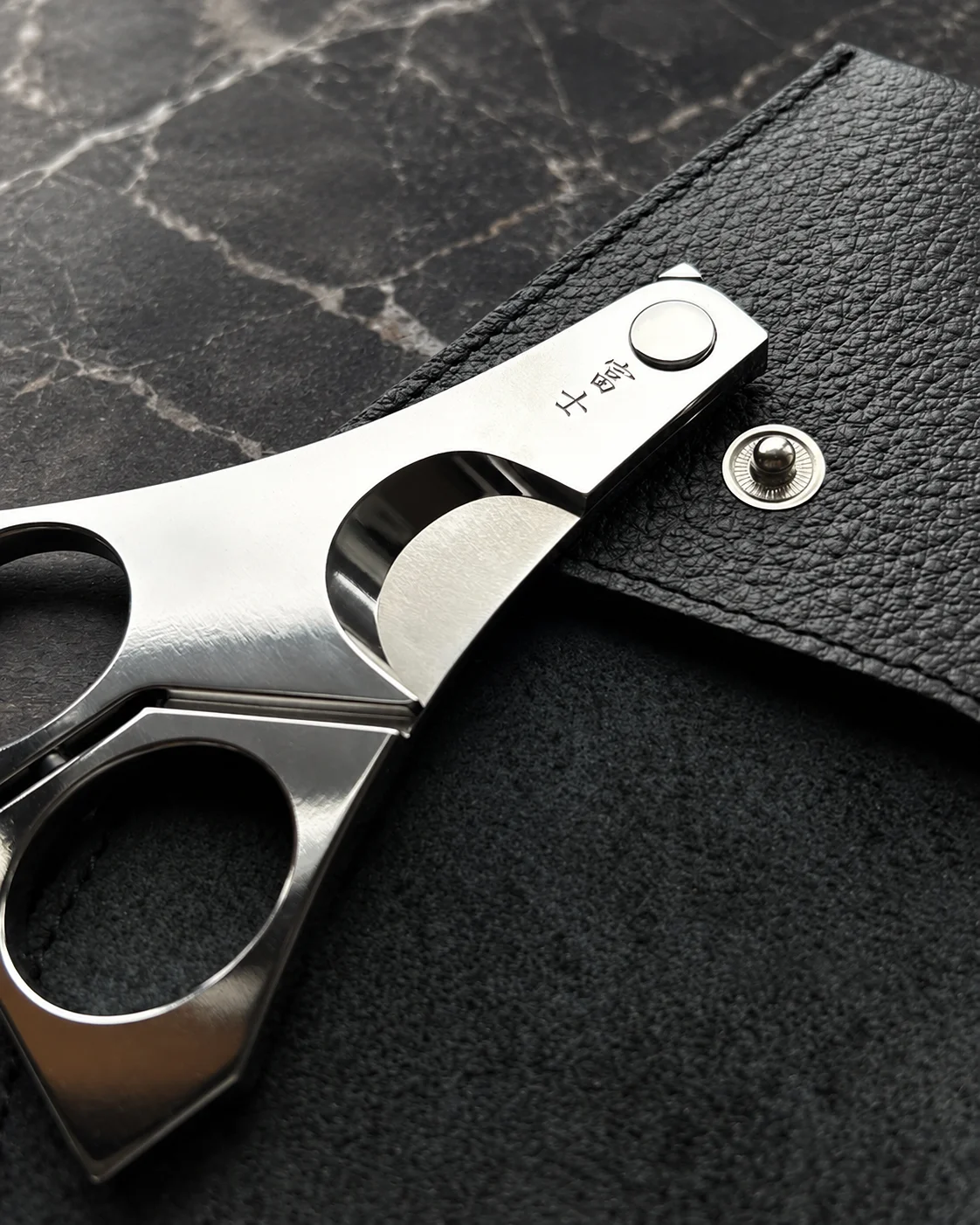 FUJI cigar scissors held alongside a cigar – compact Japanese precision instrument in context