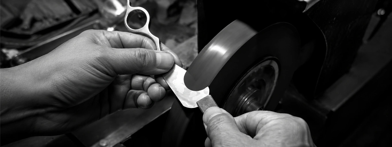 Artisan hands finishing volcanic obsidian – the standard of craft behind every Ashlar House piece