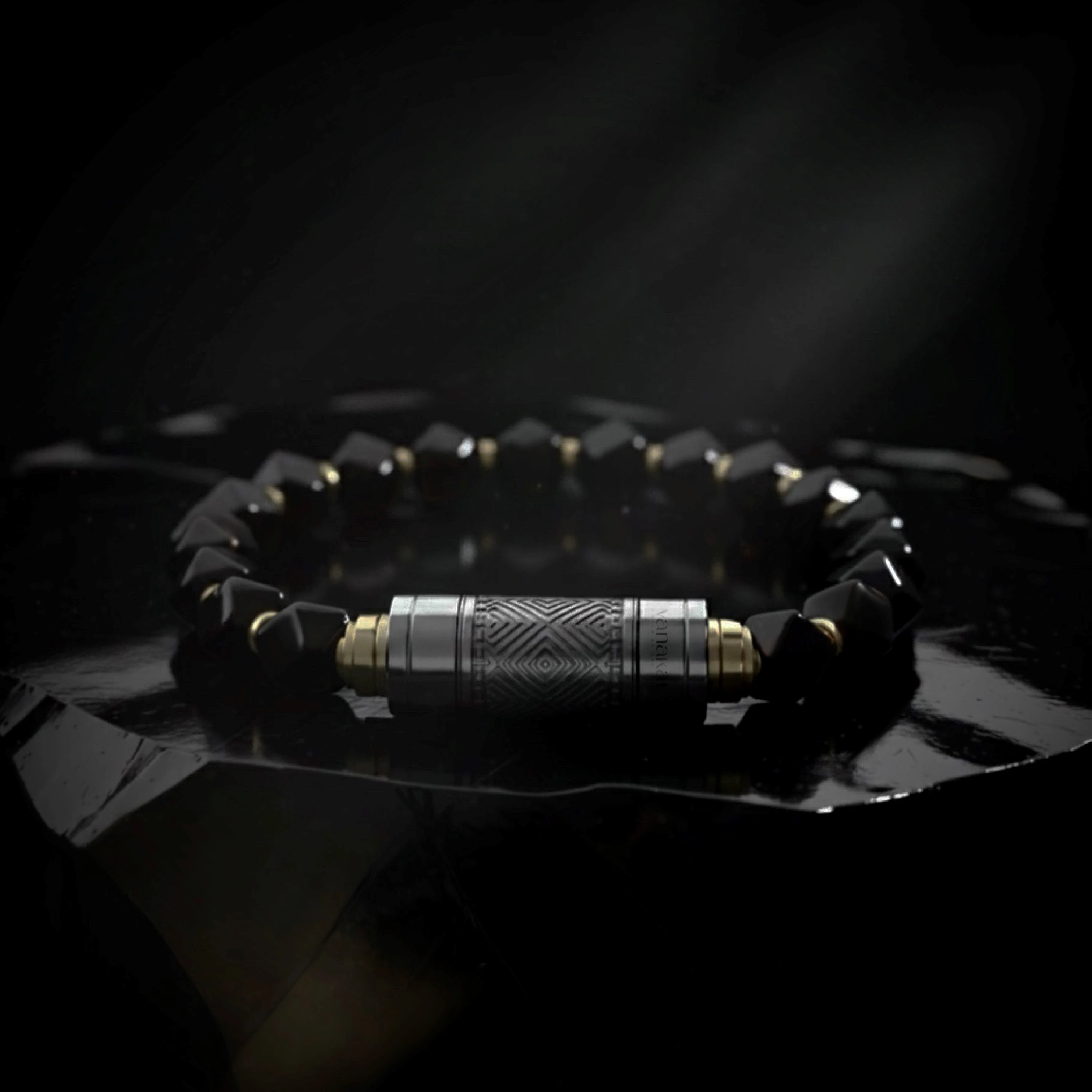 O-Punch Silver Edition – bracelet on obsidian surface, silver geometric-engraved punch tool, atmospheric lighting