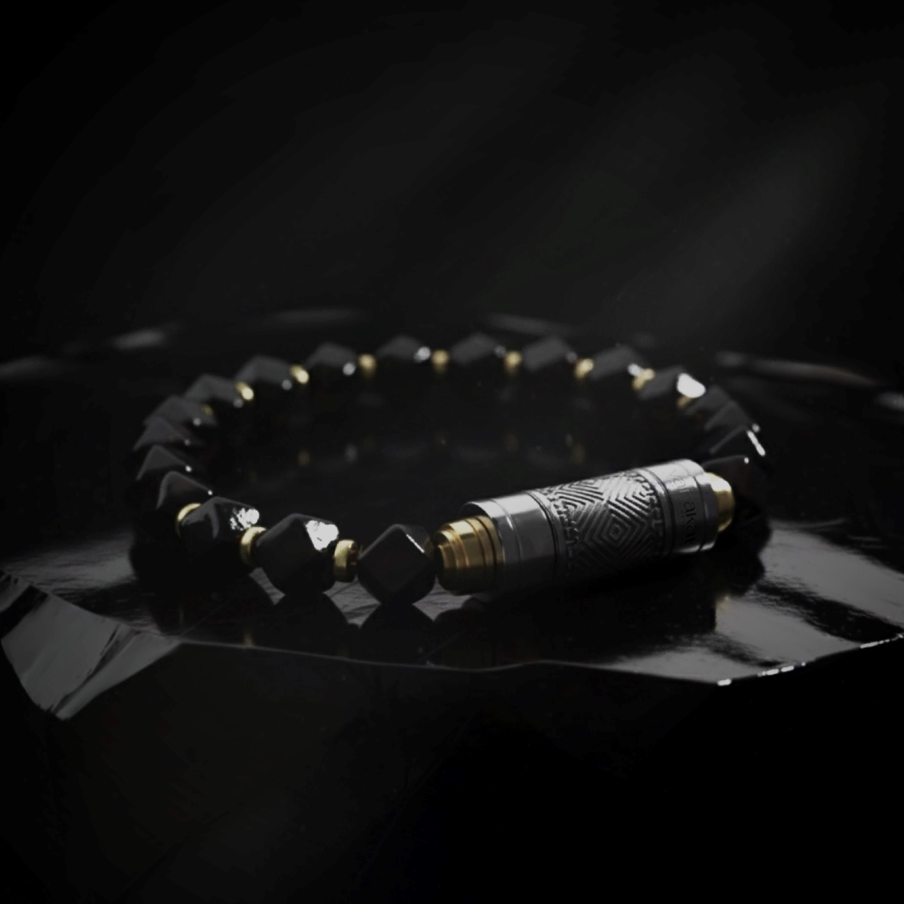 O-Punch Silver Edition – moody editorial shot on obsidian surface, silver tool with geometric engraving