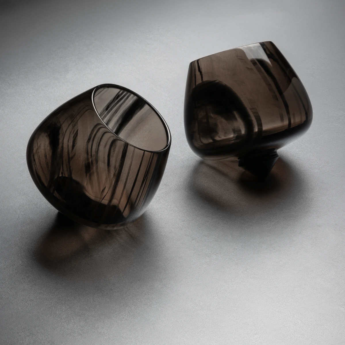 Obsidian rocking brandy glass — self-righting semi-translucent volcanic stone