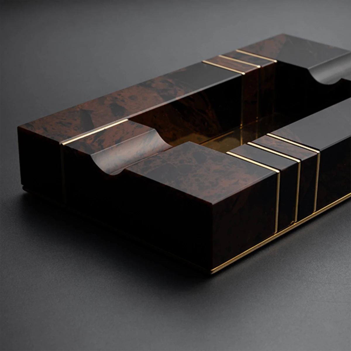 Brown & Gold ashtray — gold lines inlaid in volcanic stone, top view