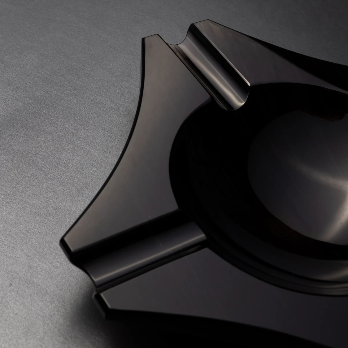 Cataleya ashtray — side profile, Jet Black volcanic stone