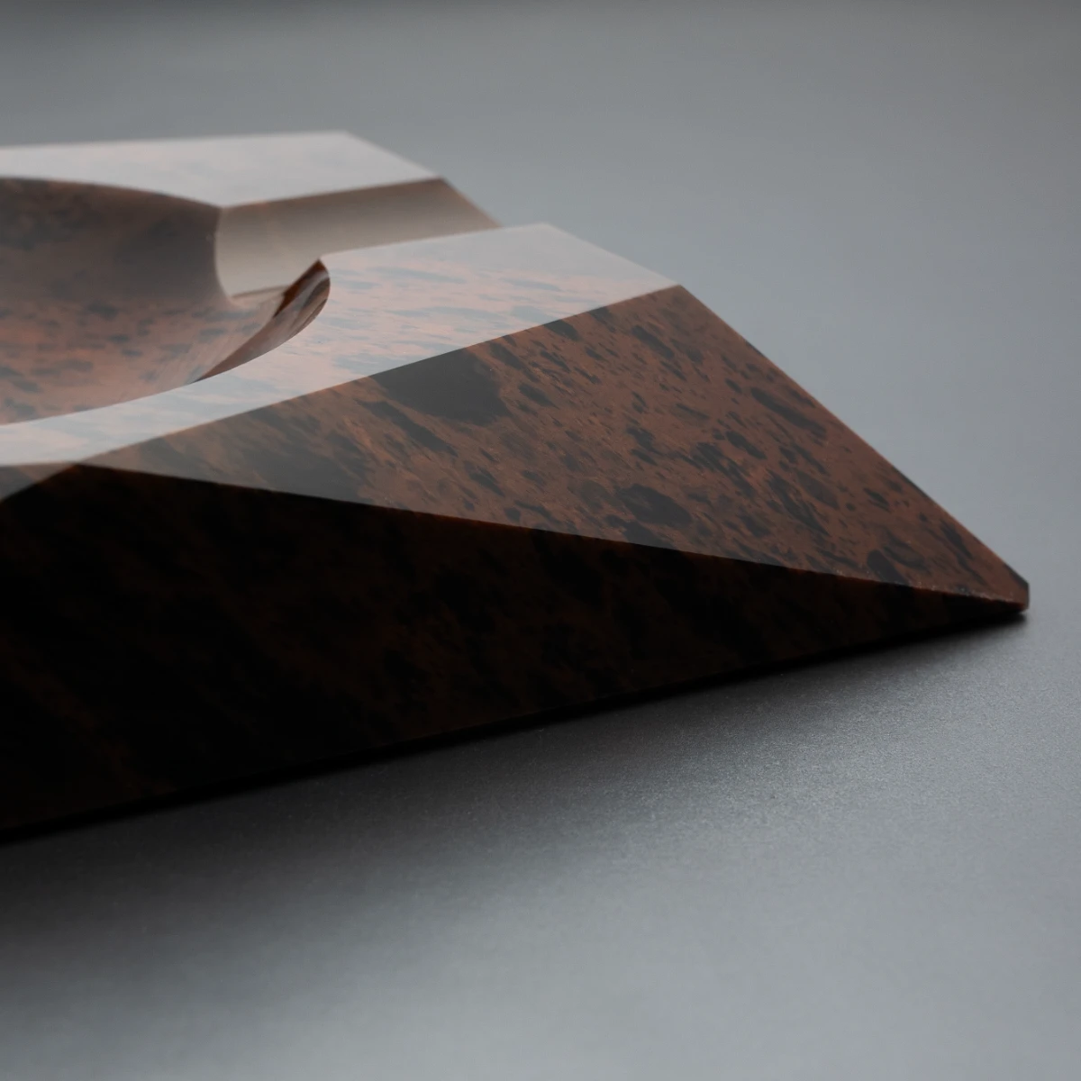 Eclipse ashtray — side profile, volcanic stone texture