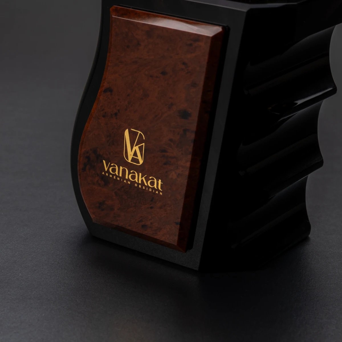 Gun Lighter — brass mechanism detail on volcanic stone base