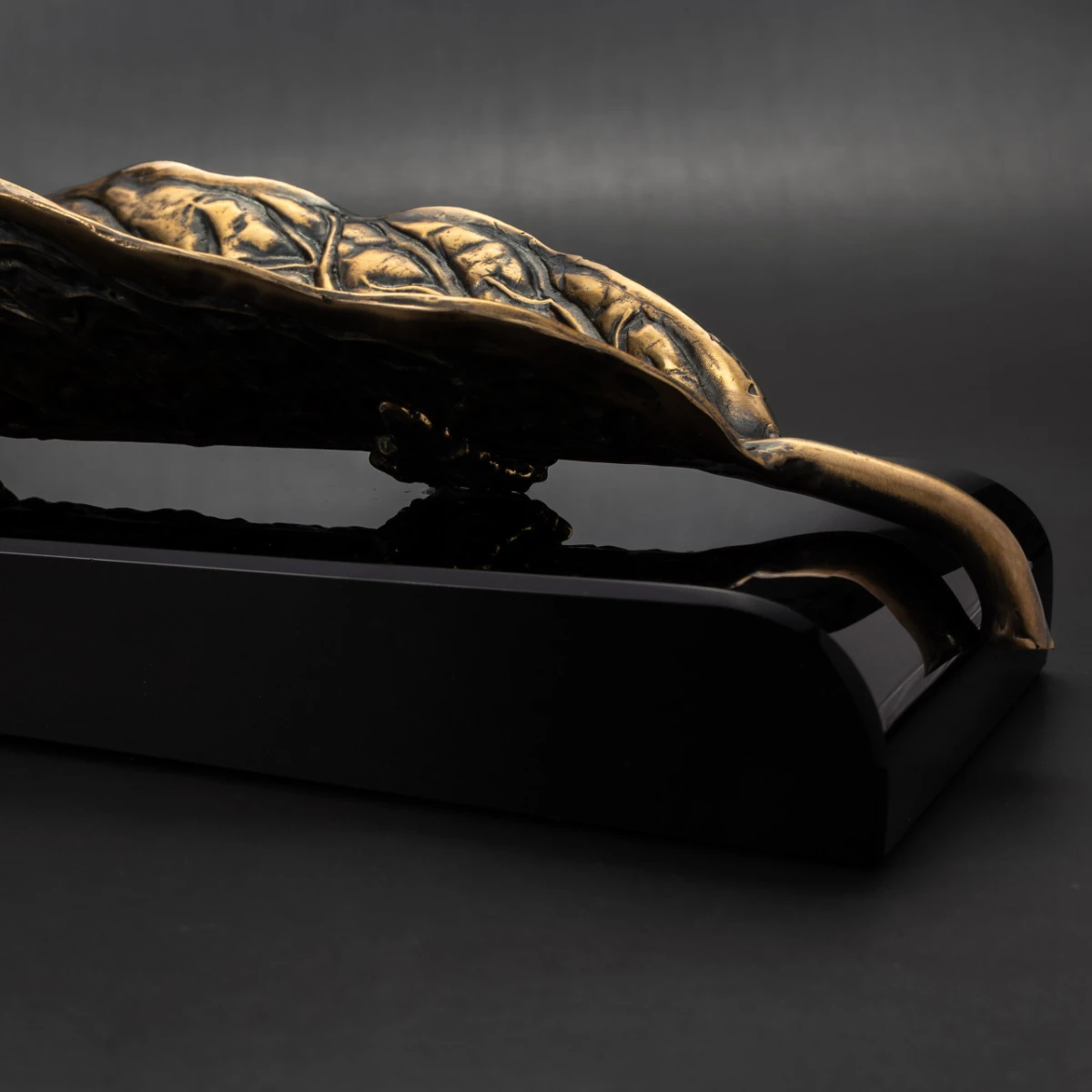 Habano Gold ashtray — angled view, gold brass leaf on volcanic stone