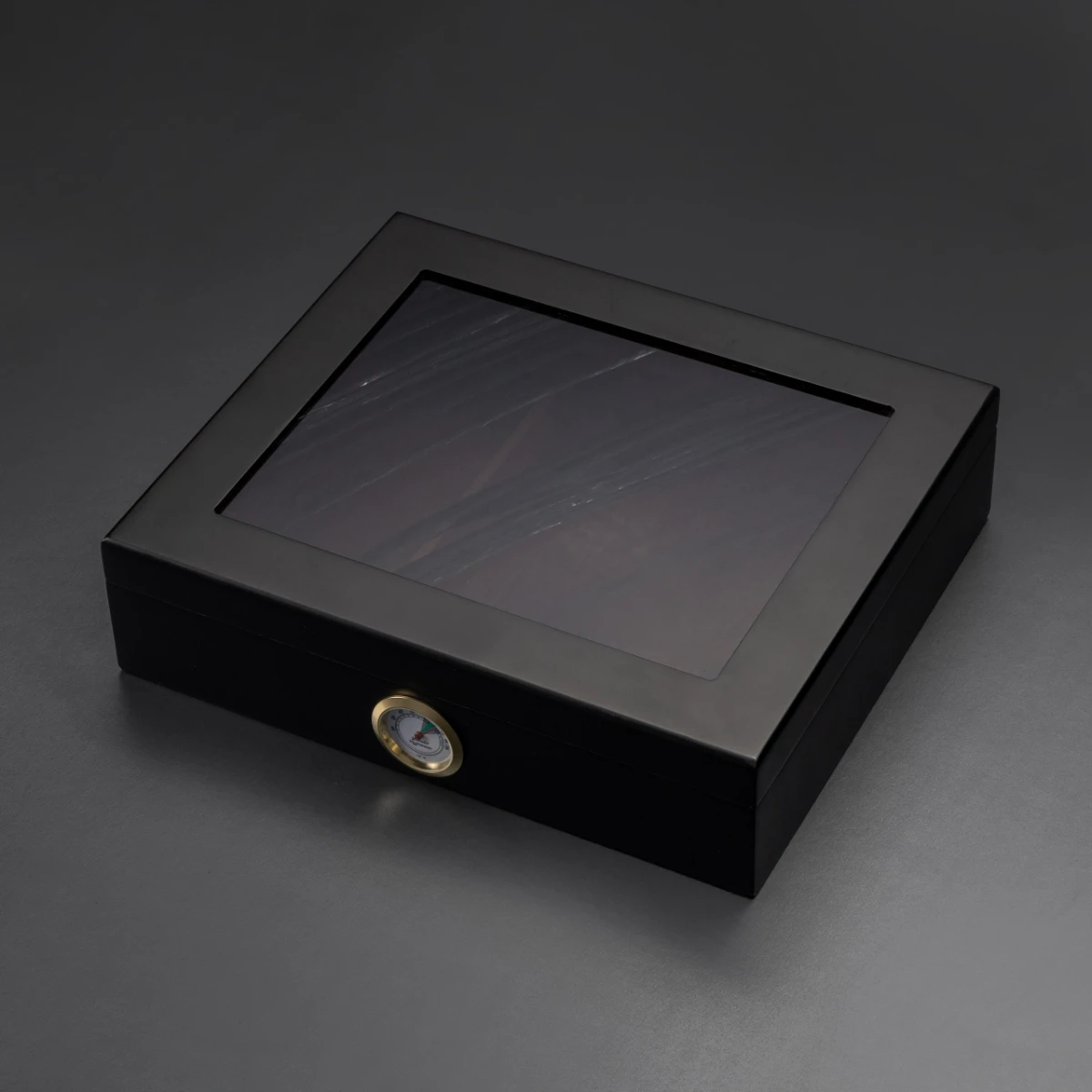 Humidor No. I — semi-translucent obsidian lid on Spanish cedar humidor, analogue hygrometer
