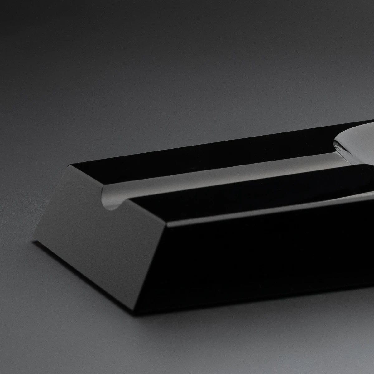 Loupe ashtray — side profile, weighted volcanic stone base