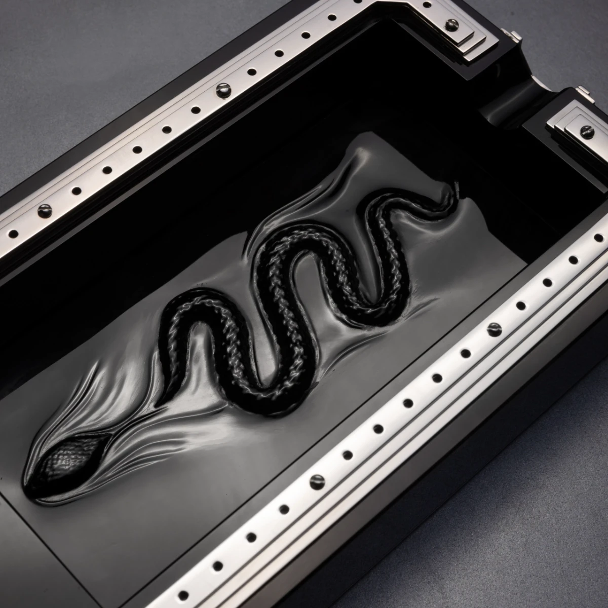 Obscura ashtray — snake sculpture detail, hand-finished obsidian