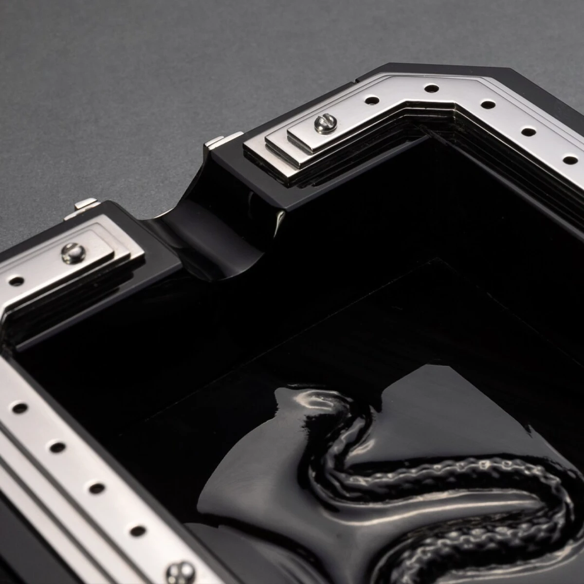 Obscura ashtray — top view, coiled snake in obsidian base