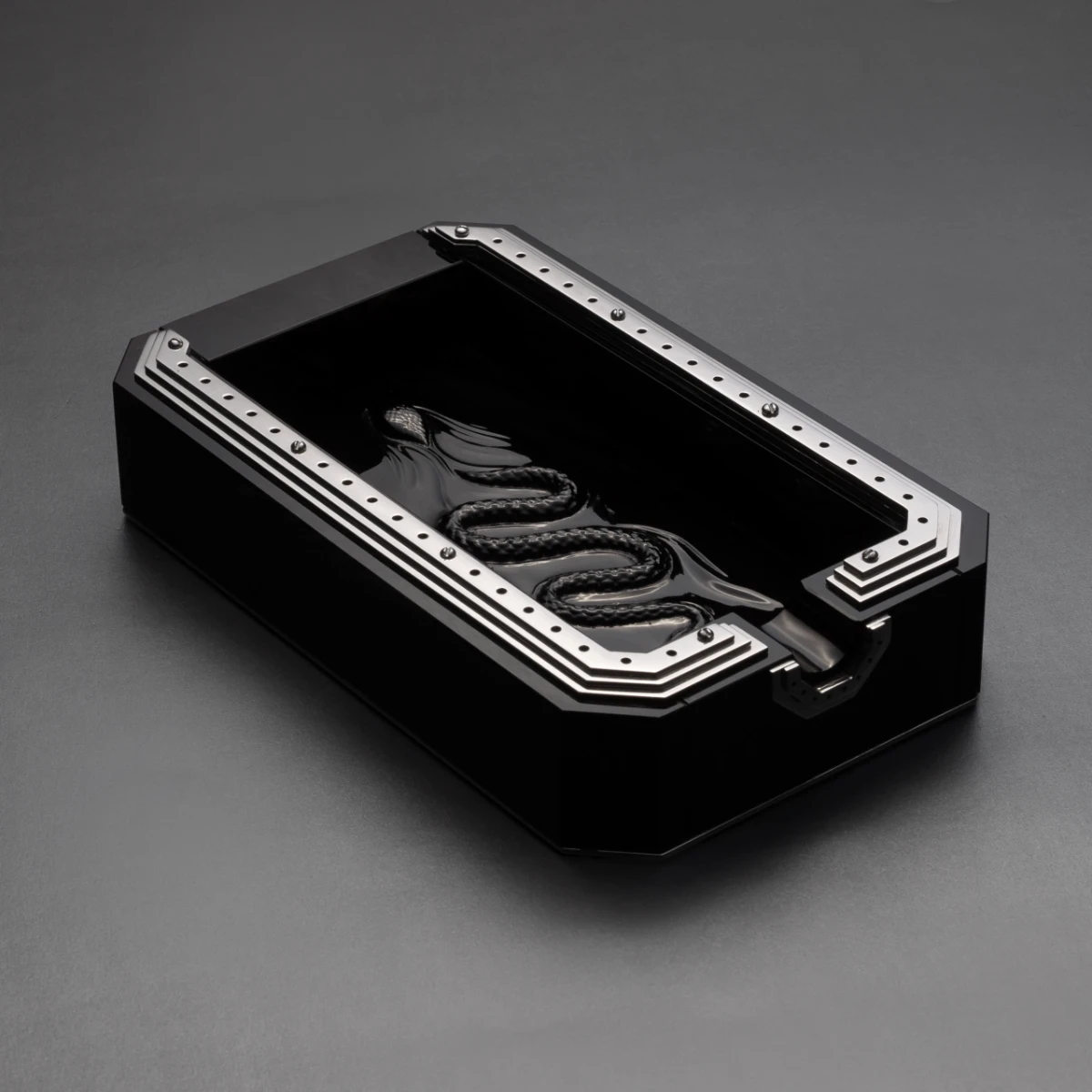 Obscura ashtray — angled view, sculptural Jet Black obsidian piece