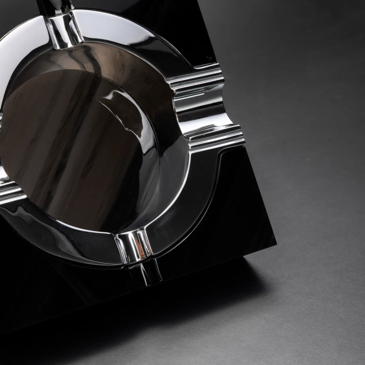 Quartet ashtray — mirror-polished obsidian base detail