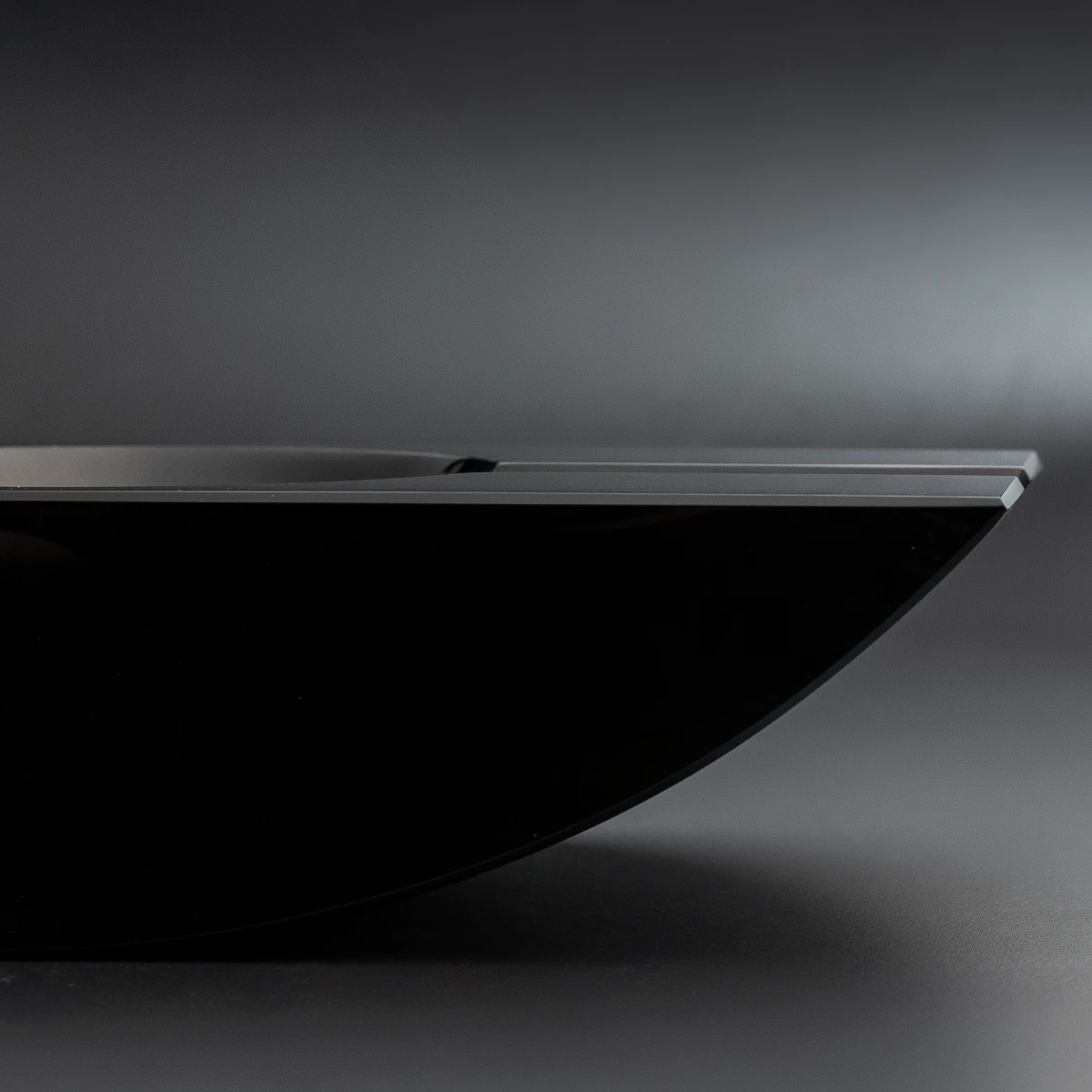 Swing ashtray — side profile, curved obsidian form